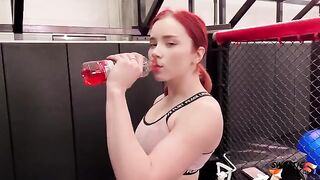 The red-haired girl is having fun with the personal trainer in the gym