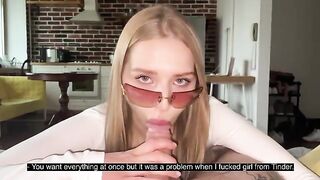 A pretty woman with glasses gets her face covered with a cumshot