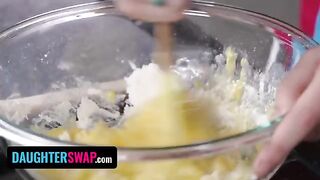 The girls are backing a pie for their stepdads in the kitchen