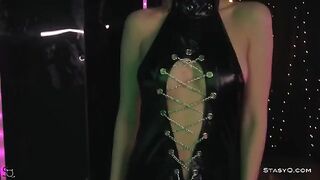 A young model AngelQ is stripping on the stage wearing black underwear