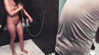 A guy gets his dick sucked off in the shower by a naughty woman