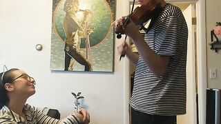 The guy tried to practice the violin but was interrupted by his passionate girlfriend
