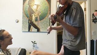 The guy tried to practice the violin but was interrupted by his passionate girlfriend