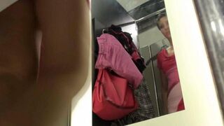 The spy camera caught a hot chick changing clothes in the locker room of the store