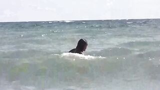 Two girls are getting a tan on the naked beach