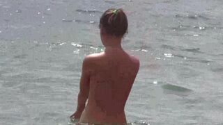 Nudist beauties have fun on the beach without any clothes