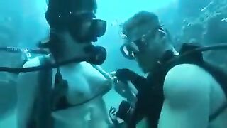 Underwater sex with aqualung divers at the bottom of the sea