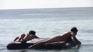 A naked girl is having fun on the beach with someone she met