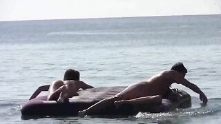 A naked girl is having fun on the beach with someone she met