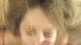 A cumshot on the face of a sexy girl after giving a blowjob