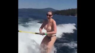 A girl has fun on the water skiing without any clothes