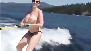 A girl has fun on the water skiing without any clothes