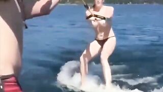A girl has fun on the water skiing without any clothes