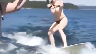 A girl has fun on the water skiing without any clothes