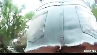 The hot brunette is jerking off her pussy on the street