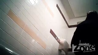 The camera is secretly filming in the toilet of a woman