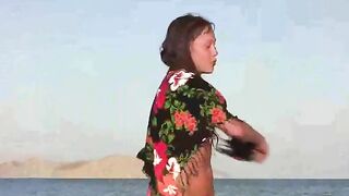 A member shows a girl the secrets of naked beach life