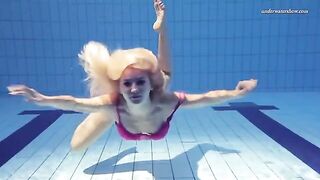 A little naked beauty swimming in the pool