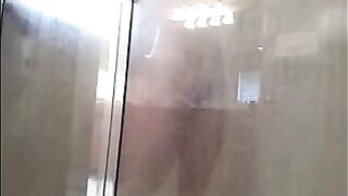 The man washes his body in the shower, camera records
