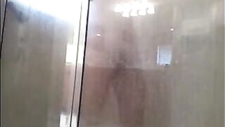 The man washes his body in the shower, camera records