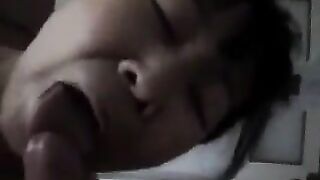 An Asian woman practices her blowjob skills on her man in a steamy homemade scene