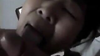 An Asian woman practices her blowjob skills on her man in a steamy homemade scene