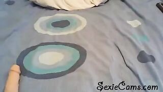 A girl tests her sex toys in front of a webcam, showcasing solo action