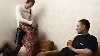 A mature woman fucks her son and his friend in this video