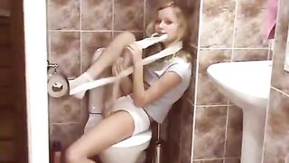 A hot young blondie gets surprised in a public toilet