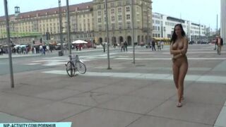 A hot chick is walking in the nude on the city streets and gets noticed