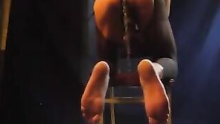 A healthy man caresses his hardened cock through pantyhose