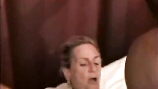A mature woman is having fun with a black guy