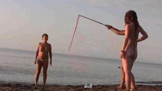 A naked beauty plays on the beach with a great body