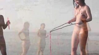 A naked beauty plays on the beach with a great body