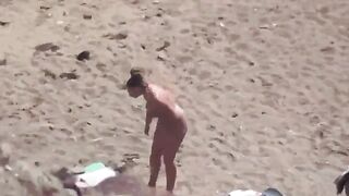 A pair of naked people enjoy themselves in the middle of the sea