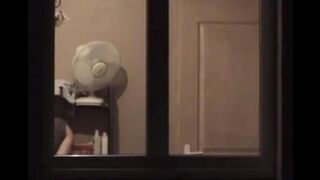 A guy admires himself in the mirror, completely naked and huge cock