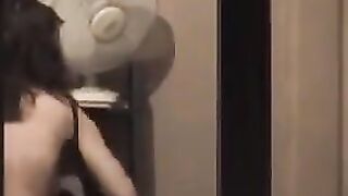 A guy admires himself in the mirror, completely naked and huge cock