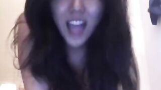 An Asian girl caresses herself, bringing pleasure with skillful fingers