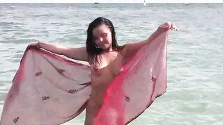 A hot girl is taking a bath in the sea naked