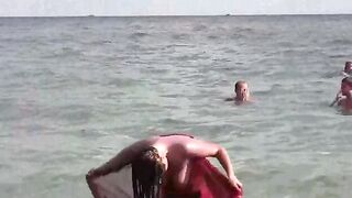 A hot girl is taking a bath in the sea naked