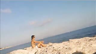 A sexy girl is basking in the sun completely naked
