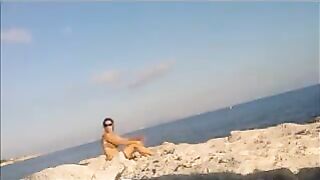 A sexy girl is basking in the sun completely naked