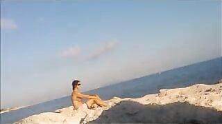 A sexy girl is basking in the sun completely naked
