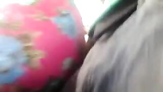 A guy checks the strength of a riser on girls in a bus