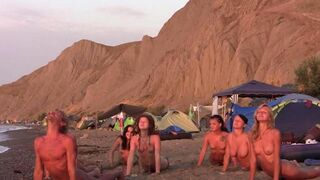A group of girls are having fun playing volleyball naked