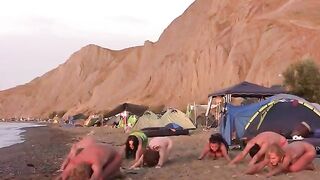 A group of girls are having fun playing volleyball naked