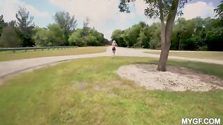 Cute woman is having fun with her boyfriend in the park outdoors