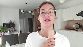 A girl has discharge and plays with it on the sheet, embodying femdom joi