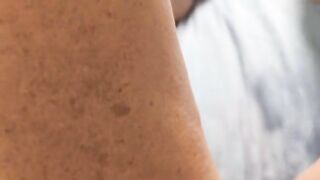 A mature woman, over 50, indulges in solo pleasure with intense fingering and squirting